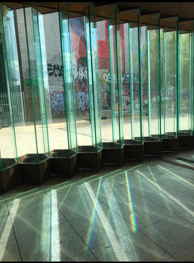 Artist Wendy Hardie's 'Molecular Glass Wall' Installation at the newly created Hackney Wick Station (2014-18) refracting the sunlight into bands of pure pigment evoking The Wick's historic innovative dye industry.